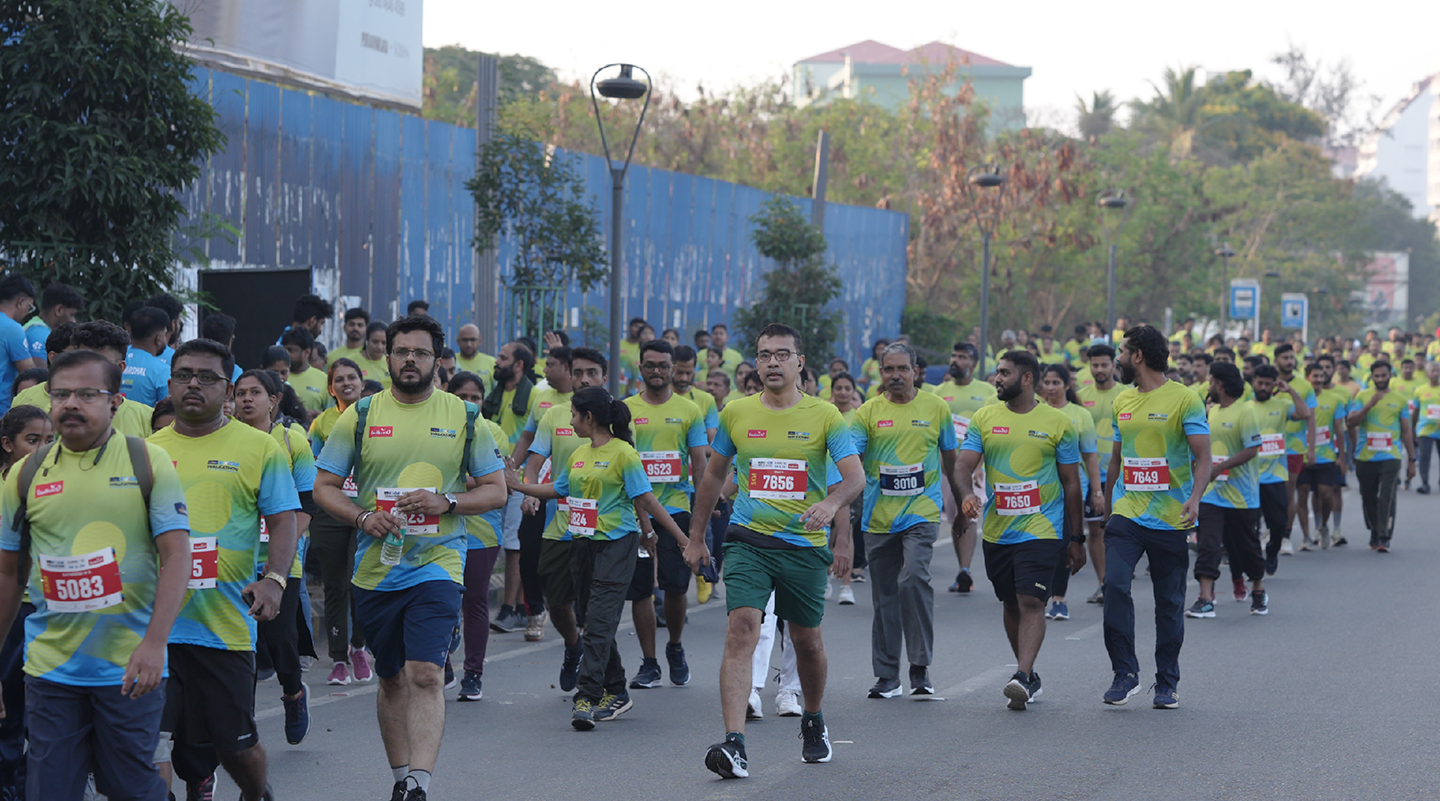 Participants in Kochi Walkathon walking along the road